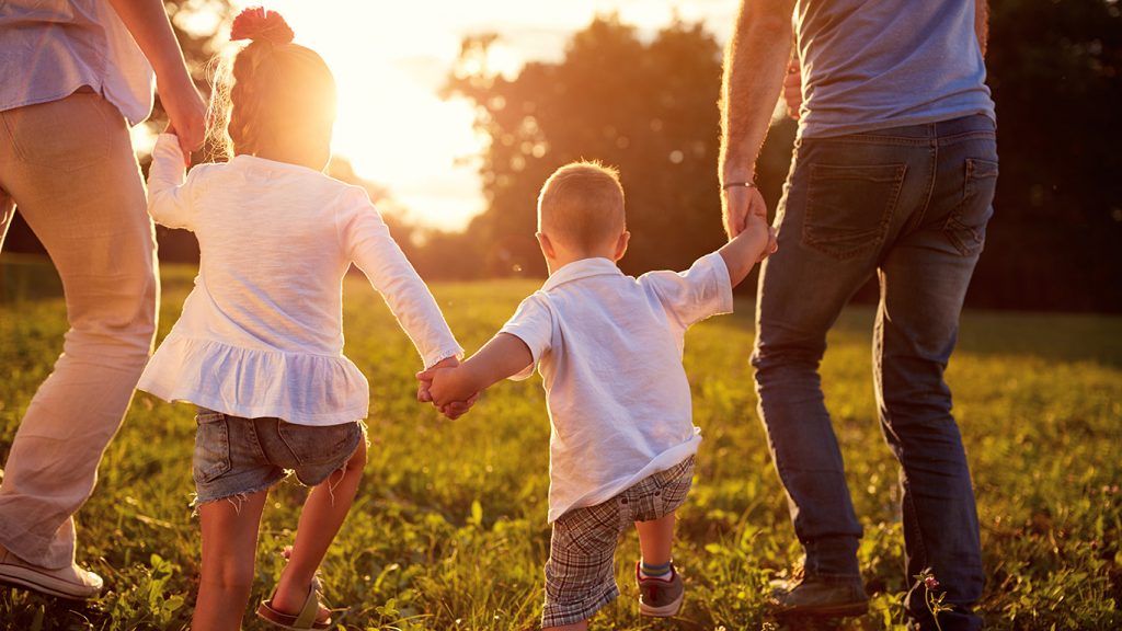 Family With Small Children Holding Hands